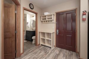 a bathroom with a toilet and a clock on the wall at Premium Unit 2216 - 1 Br - Zephyr Mountain Lodge condo in Winter Park