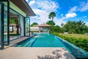 a swimming pool in the backyard of a house at Banyan Tree Grand Residences by Banyan Living in Phuket Town