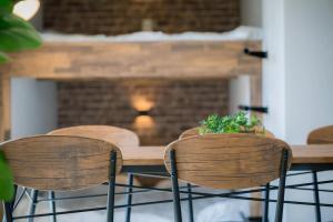 a wooden table with four chairs and a fireplace at A&m花畑501 in Kumamoto
