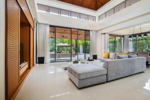 a living room with a couch and a table at Banyan Tree Grand Residences by Banyan Living in Phuket Town