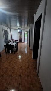 a hallway with a dining room and a table and chairs at Casa Palmera in Puerto Jiménez