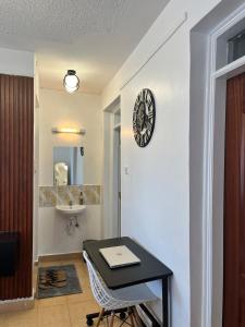 a bathroom with a black table and a sink at Tranquil Luxury Stay, Utawala, JKIA View in Nairobi