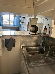 a kitchen with a sink and a coffee maker at Hygge Ski-in-Ski-out med udsigt in Avoriaz