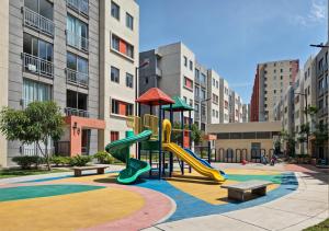 a playground with slides and benches in a city at Loft en Nrt de Barranquilla - Piscina - Mall 3 Min in Barranquilla