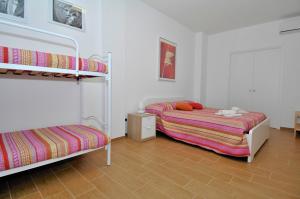 A bed or beds in a room at B&B Nonna Roma