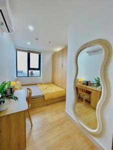 a living room with a bed and a mirror at Amy Apartment in Nera Garden Hue in Thôn Văn Dương +87 photos