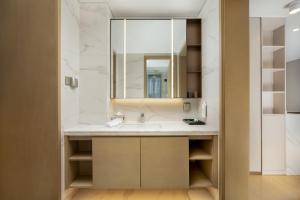 a bathroom with a sink and a mirror at 苏州山塘街华贸姑苏里酒店公寓 in Suzhou
