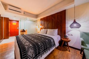 Postel nebo postele na pokoji v ubytování MaxOneHotels at Ubud - CHSE Certified + 37 fotografií