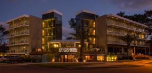 a couple of tall buildings at night at 2122 Hotel Art Design in Punta del Este
