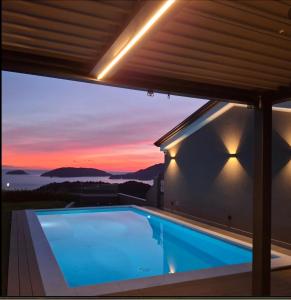 a house with a swimming pool at dusk at Colori di Mare Luxury Holiday in Lerici