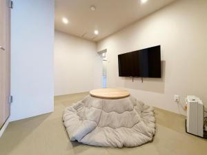 a room with a bean bag chair and a flat screen tv at Celine Kanayama by b hotel in Hiroshima