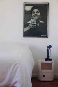 a black and white photo of a woman holding a drink at Luxury Condo in Setúbal in Setúbal
