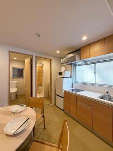 a kitchen with a table and a dining room at Celine Kanayama Building in Hiroshima