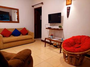 a living room with two couches and a tv at Golden Villa Kandy in Kandy