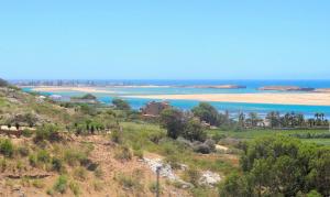 a view of the beach and the ocean at Maison de la Lagune in Oualidia