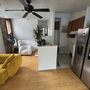 a kitchen and living room with a ceiling fan at Dc Play House Bed and Breakfast in Washington +12 photos