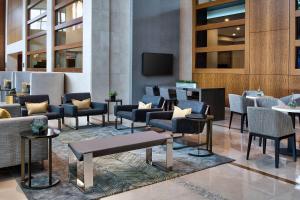 a lobby with chairs and tables and a television at Wyndham Atlanta Buckhead Hotel & Conference Center in Atlanta +56 photos