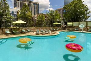 a large swimming pool with chairs and umbrellas at Wyndham Atlanta Buckhead Hotel & Conference Center in Atlanta