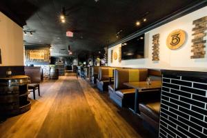 a restaurant with couches and tables and a bar at Hotel Lex and Conference Center, Trademark Collection in Lexington
