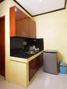 a kitchen with a sink and a counter top at Leonida's Exclusive Resort in Talisay