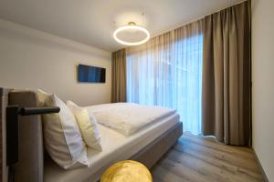 Ένα ή περισσότερα κρεβάτια σε δωμάτιο στο LH Suites Aparthotel NEW OPENING inkl JokerCard
