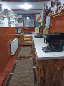 a kitchen with wooden counters and a counter top at Coliba Padurarului in Porumbacu de Jos +23 photos