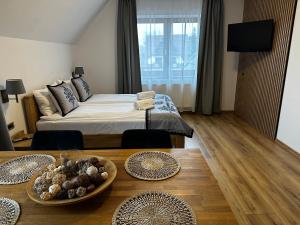 a bedroom with a bed and a table with a bowl of food at DW Szarotka in Białka Tatrzanska