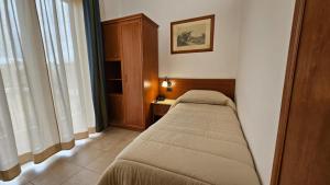 Postel nebo postele na pokoji v ubytování GH Hotel