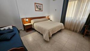 Postel nebo postele na pokoji v ubytování GH Hotel