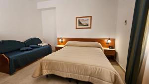 Postel nebo postele na pokoji v ubytování GH Hotel