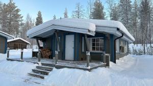 a small cabin with snow on top of it at Chalet Pellonranta 1 in Pello