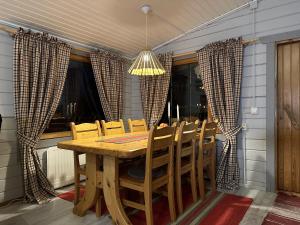 a dining room with a wooden table and chairs at Chalet Pellonranta 1 in Pello