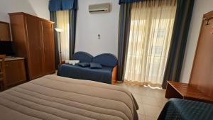 Postel nebo postele na pokoji v ubytování GH Hotel