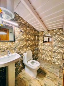 a bathroom with a toilet and a sink at Priory Cottage Heritage Haven in Nainital +41 photos