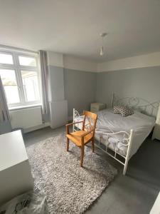 a bedroom with a bed with a chair and a rug at Contractors Rooms In Fawley in Fawley