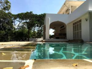 a swimming pool in front of a house at Villa Maridadi in Ukunda Airport