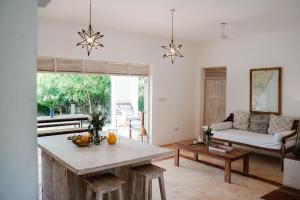 a living room with a table and a couch at Villa Maridadi in Ukunda Airport +30 photos