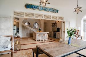 a living room with a table and a kitchen at Villa Maridadi in Ukunda Airport