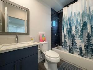 a bathroom with a toilet and a shower curtain at Blue Hostel Walk to BMO Stadium and USC in Los Angeles +68 photos
