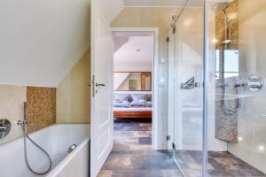 ein Badezimmer mit Dusche und Badewanne in der Unterkunft Kapitäns Hus Ferienhaus Avantgarde in Putbus + 19 Fotos
