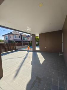 an empty patio with a view of a house at aSU villa in Ban Huai Yai