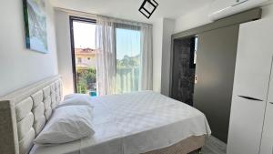 a bedroom with a bed and a large window at Villa Zümrüt in Ortaca +24 photos