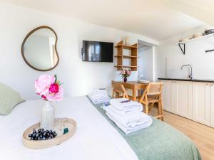 a room with a bed and a table with towels at Studio COSY in the heart of Paris - Mobility lease in Paris