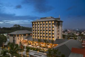 a hotel with a lit up building in a city at Modena by Fraser Vinh Yen in Yen