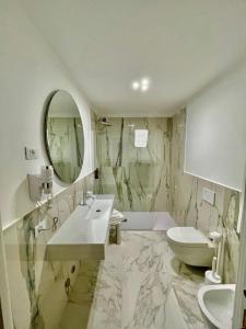 a bathroom with a sink and a toilet and a mirror at Console Palais in Venice +48 photos