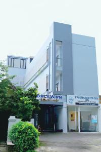 a white building with a sign that reads ballatown at Djuragan Kamar Balawan in Bareng
