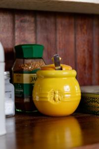 a yellow vase sitting on top of a table at Ebernburg Cottage in Nottingham Road