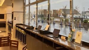 a library with two laptop computers on a counter at Toyoko Inn Hokkaido Shin Hakodate Hokuto eki Minami guchi in Hokuto