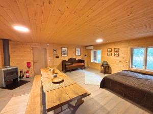 a large room with a bed and a wooden ceiling at Hus Upplångö in Figeholm