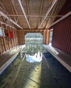 an inside view of a building with water in it at Hus Upplångö in Figeholm